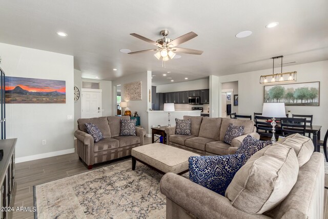 living room featuring ceiling fan and dark hardwood / wood-style flooring