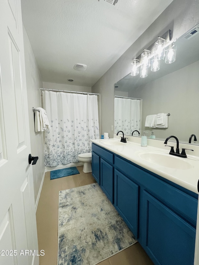 7136 N 73rd Dr, Glendale, AZ 85303 - bathroom with toilet, double vanity, a sink, and visible vents