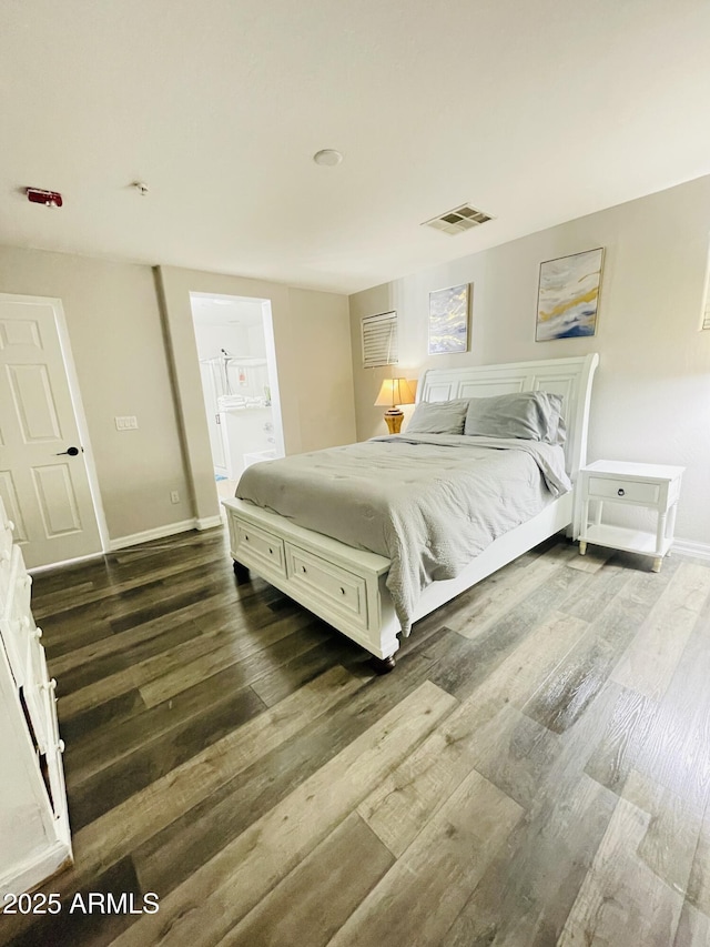 7136 N 73rd Dr, Glendale, AZ 85303 - bedroom with visible vents, baseboards, ensuite bath, and wood finished floors