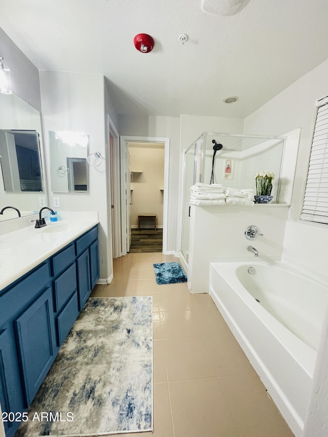 7136 N 73rd Dr, Glendale, AZ 85303 - full bath featuring vanity, baseboards, tile patterned floors, a shower stall, and a garden tub