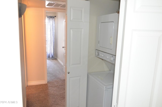 laundry area featuring carpet floors and stacked washer and dryer