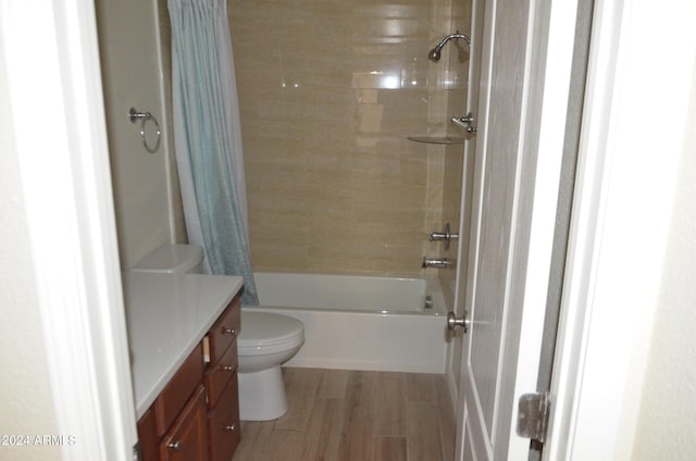 full bathroom featuring vanity, wood-type flooring, shower / bath combo, and toilet