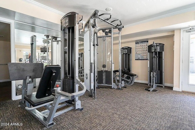 exercise room with dark colored carpet and ornamental molding