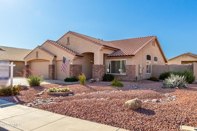 5524 E Garnet Cir, Mesa, AZ 85206 - mediterranean / spanish-style home with stone siding, a garage, stucco siding, and a tile roof