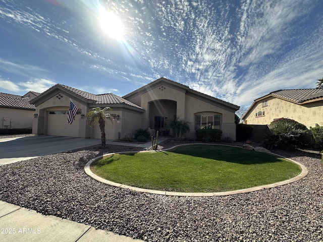 mediterranean / spanish home with a garage and a front yard