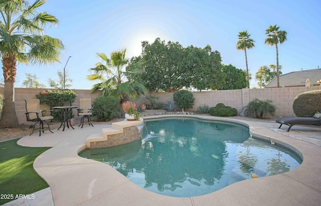 view of swimming pool with a patio and pool water feature