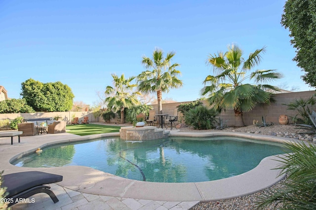 view of swimming pool with a patio and pool water feature