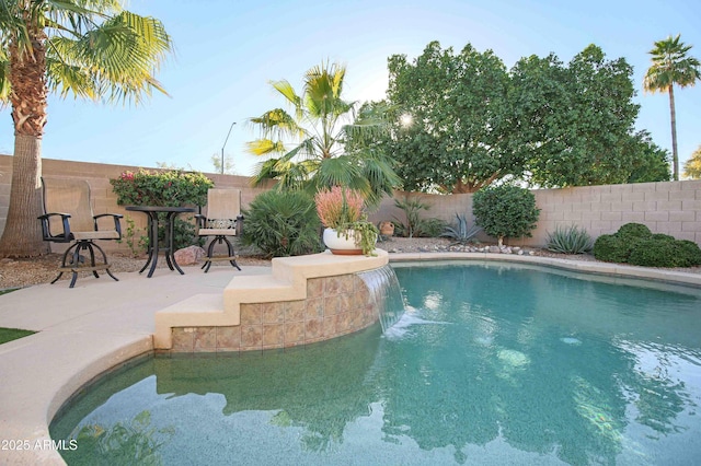 view of swimming pool featuring a patio and pool water feature