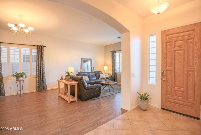 foyer featuring a notable chandelier and light hardwood / wood-style floors