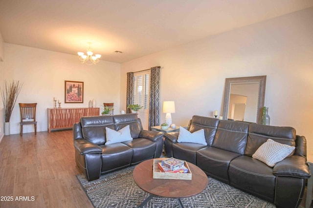 living room featuring hardwood / wood-style floors and a notable chandelier