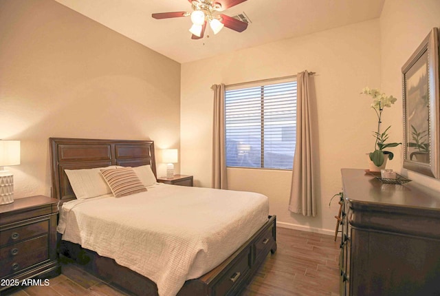 bedroom with dark hardwood / wood-style floors and ceiling fan