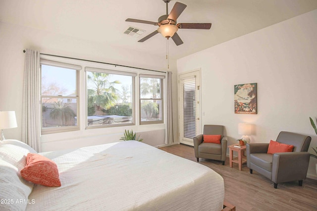 bedroom with hardwood / wood-style flooring, access to outside, and ceiling fan