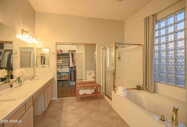 bathroom featuring vanity, tile patterned floors, and shower with separate bathtub