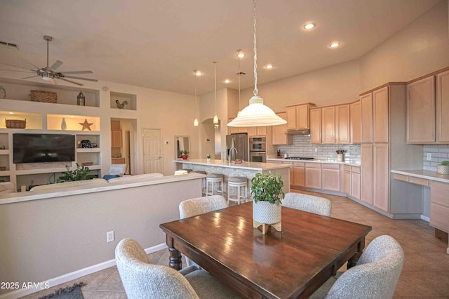 tiled dining space featuring ceiling fan