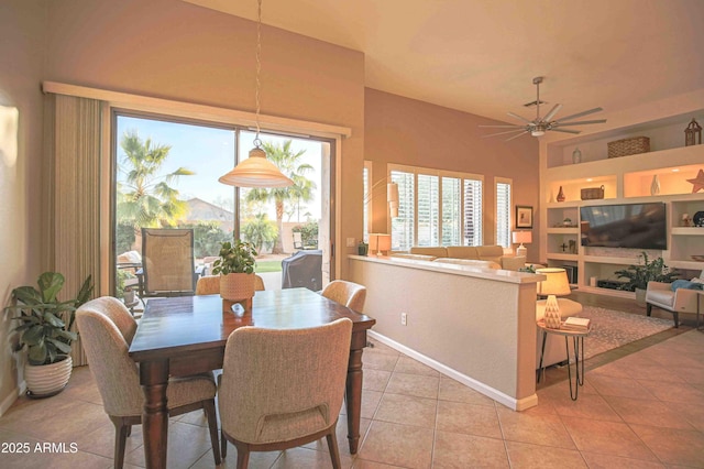 dining room with built in features, ceiling fan, and light tile patterned flooring