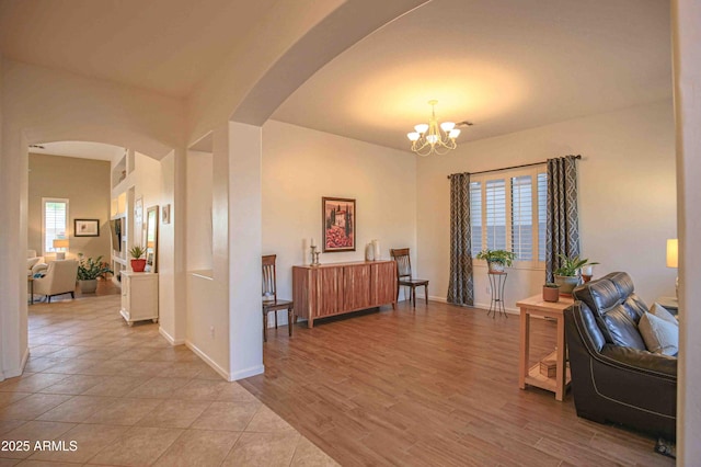 interior space featuring a notable chandelier and light hardwood / wood-style floors