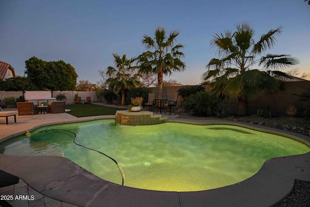 pool at dusk with a patio