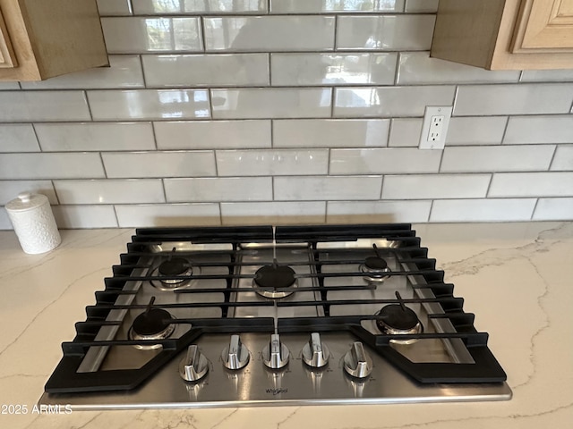 details featuring tasteful backsplash and stainless steel gas stovetop