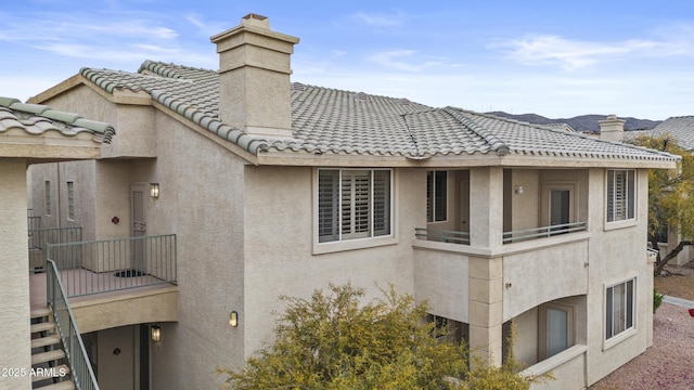 16013 S Desert Foothills Pkwy Unit 2120, Phoenix, AZ 85048 - exterior space featuring a tile roof, stucco siding, a chimney, and a balcony