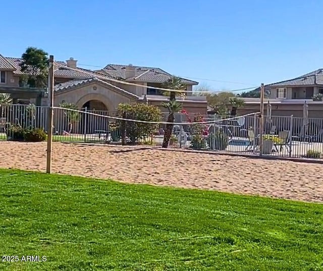 view of home's community featuring a lawn and volleyball court