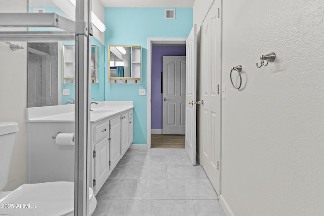 16013 S Desert Foothills Pkwy Unit 2120, Phoenix, AZ 85048 - bathroom featuring visible vents, baseboards, toilet, tile patterned floors, and vanity