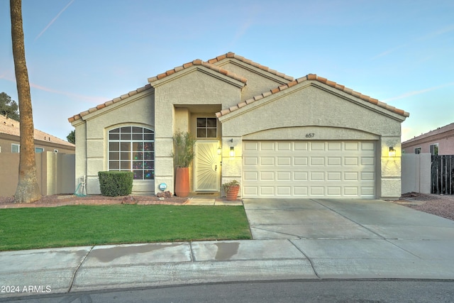 view of front of home with a front lawn and a garage