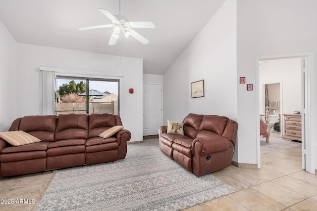 tiled living room featuring ceiling fan and vaulted ceiling