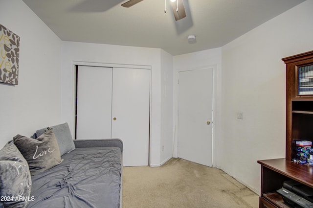 interior space with ceiling fan and a closet