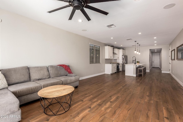 40470 W Agave Rd, Maricopa, AZ 85138 - living area featuring a ceiling fan, dark wood-style flooring, baseboards, and recessed lighting