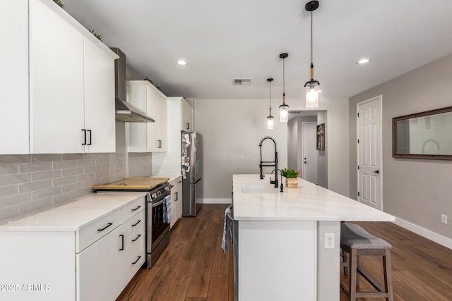40470 W Agave Rd, Maricopa, AZ 85138 - kitchen featuring appliances with stainless steel finishes, wall chimney exhaust hood, a sink, baseboards, and backsplash