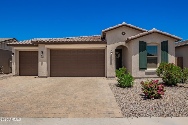 40470 W Agave Rd, Maricopa, AZ 85138 - mediterranean / spanish-style home with a garage, decorative driveway, stucco siding, and a tile roof