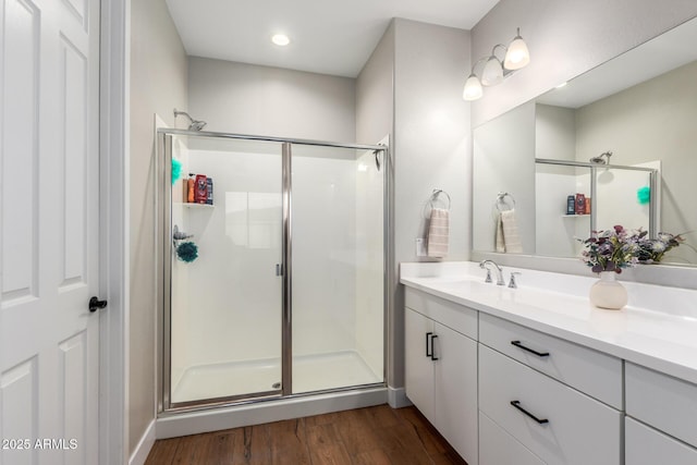 40470 W Agave Rd, Maricopa, AZ 85138 - bathroom with a stall shower, wood finished floors, vanity, and recessed lighting