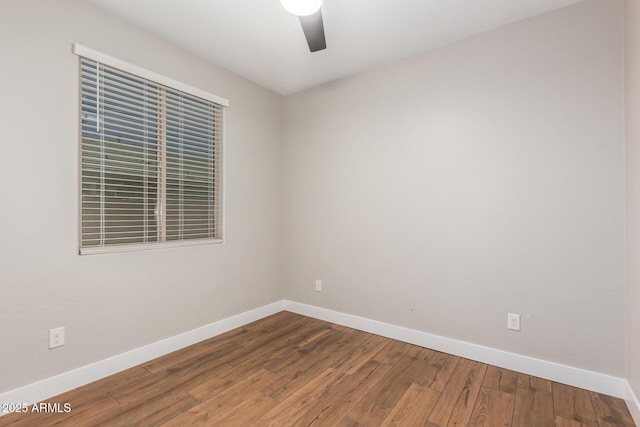 40470 W Agave Rd, Maricopa, AZ 85138 - empty room featuring baseboards, wood finished floors, and a ceiling fan