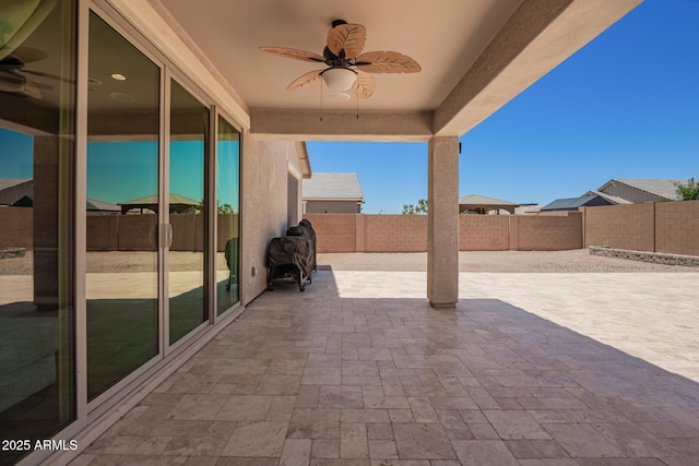 40470 W Agave Rd, Maricopa, AZ 85138 - fenced backyard with ceiling fan and a patio area