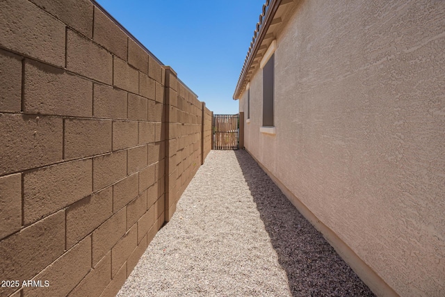 40470 W Agave Rd, Maricopa, AZ 85138 - view of home's exterior featuring stucco siding and a gate