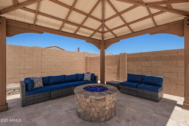 40470 W Agave Rd, Maricopa, AZ 85138 - fenced backyard featuring an outdoor living space with a fire pit and a patio area