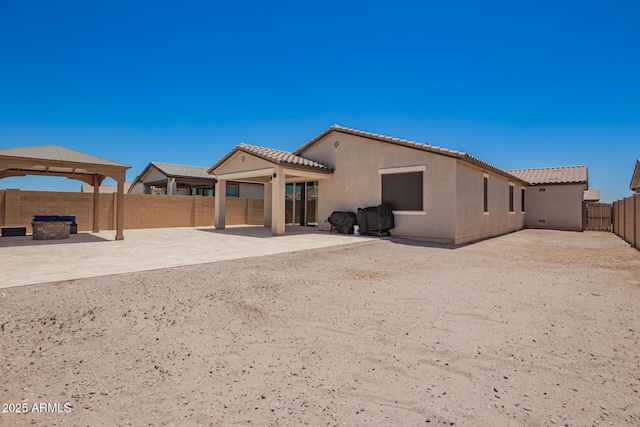 40470 W Agave Rd, Maricopa, AZ 85138 - rear view of house featuring a patio, a gazebo, a fenced backyard, and stucco siding