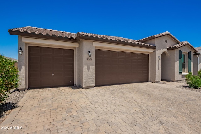 40470 W Agave Rd, Maricopa, AZ 85138 - mediterranean / spanish house with an attached garage, stucco siding, and decorative driveway