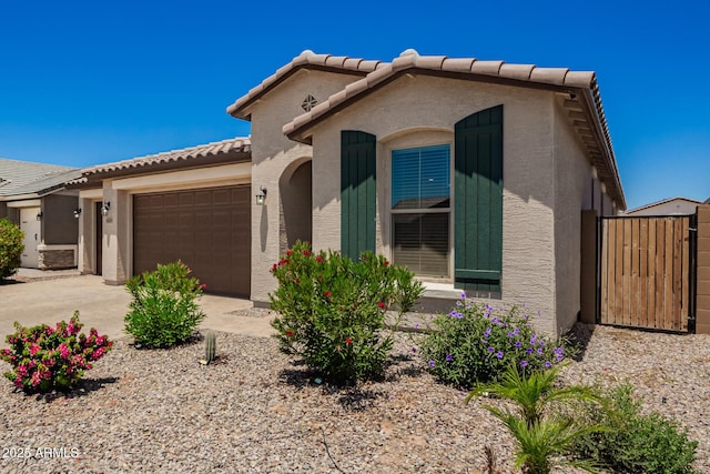 40470 W Agave Rd, Maricopa, AZ 85138 - view of front of property with a tiled roof, an attached garage, stucco siding, and a gate