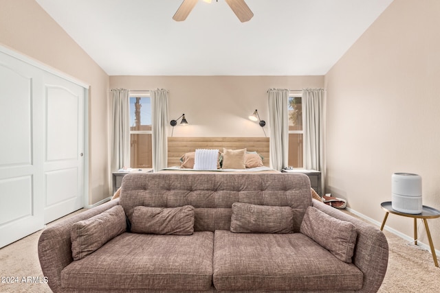 bedroom with lofted ceiling, ceiling fan, and carpet flooring