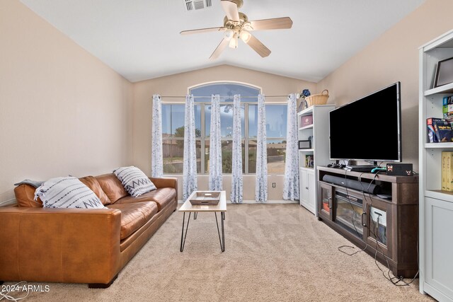 carpeted living room with vaulted ceiling and ceiling fan