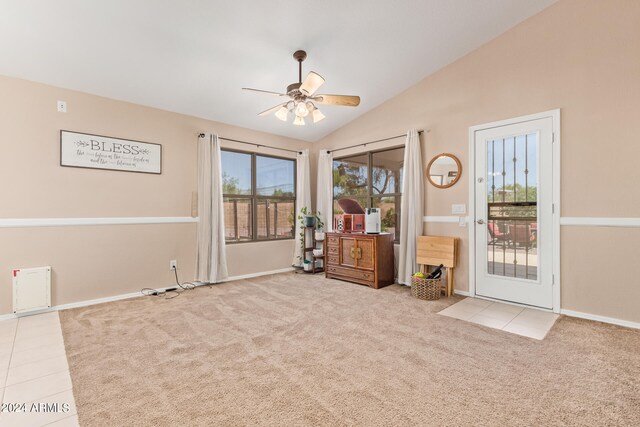 unfurnished room featuring light colored carpet, vaulted ceiling, and ceiling fan