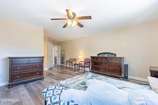 bedroom with a ceiling fan, light wood-style flooring, and baseboards