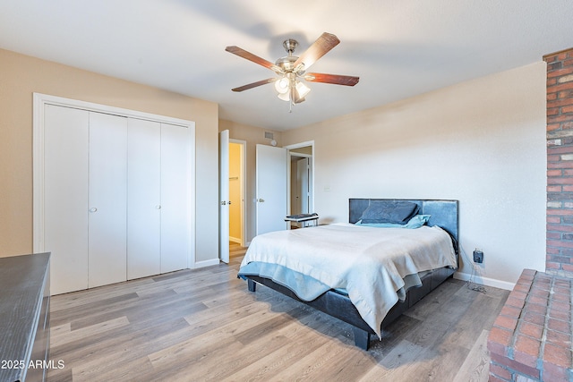 bedroom featuring light wood-style floors, a closet, ceiling fan, and baseboards