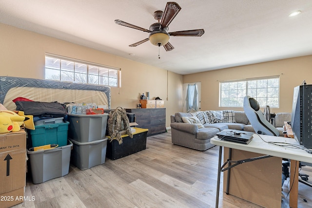 living room with wood finished floors and a ceiling fan