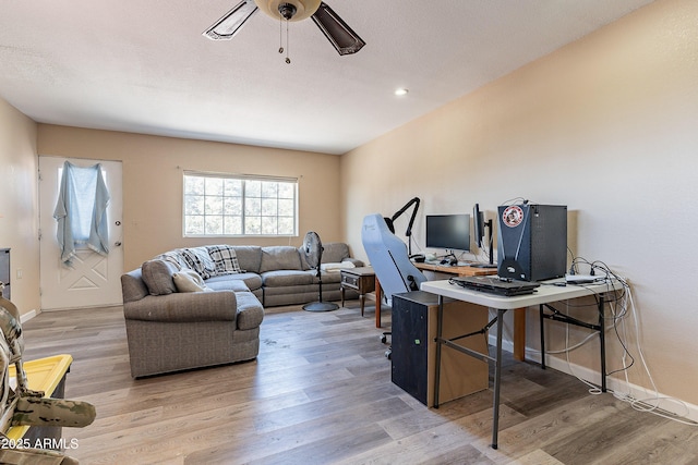 office area with ceiling fan, a textured ceiling, baseboards, and wood finished floors