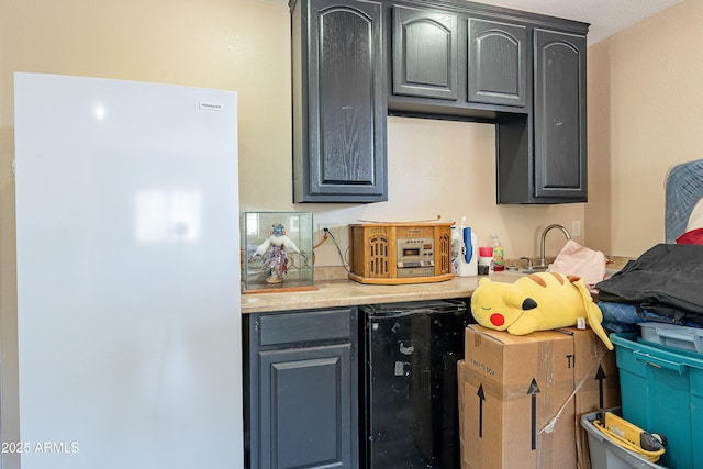 kitchen with beverage cooler, light countertops, and freestanding refrigerator