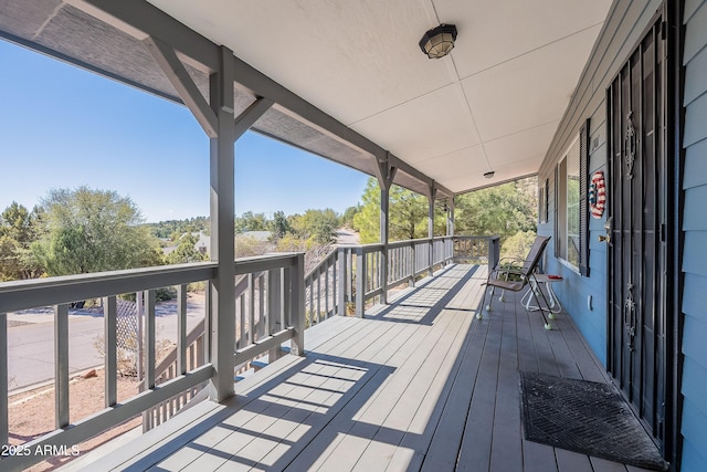 wooden terrace featuring covered porch