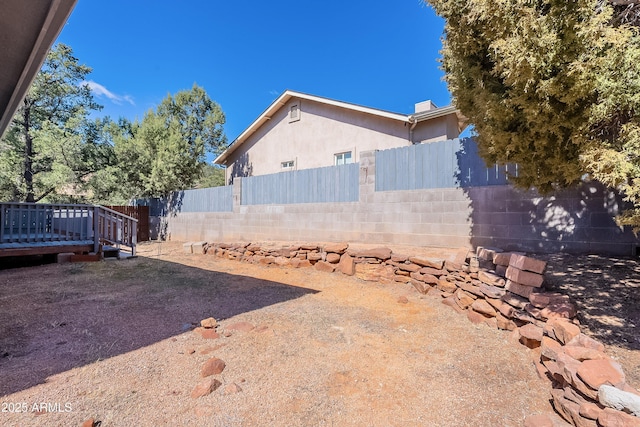 view of yard featuring a fenced backyard and a wooden deck