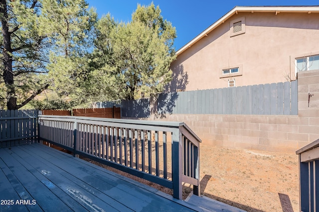 wooden terrace featuring a fenced backyard